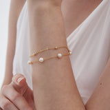 Duo Layer Natural Pearl Bracelet in gold on hand