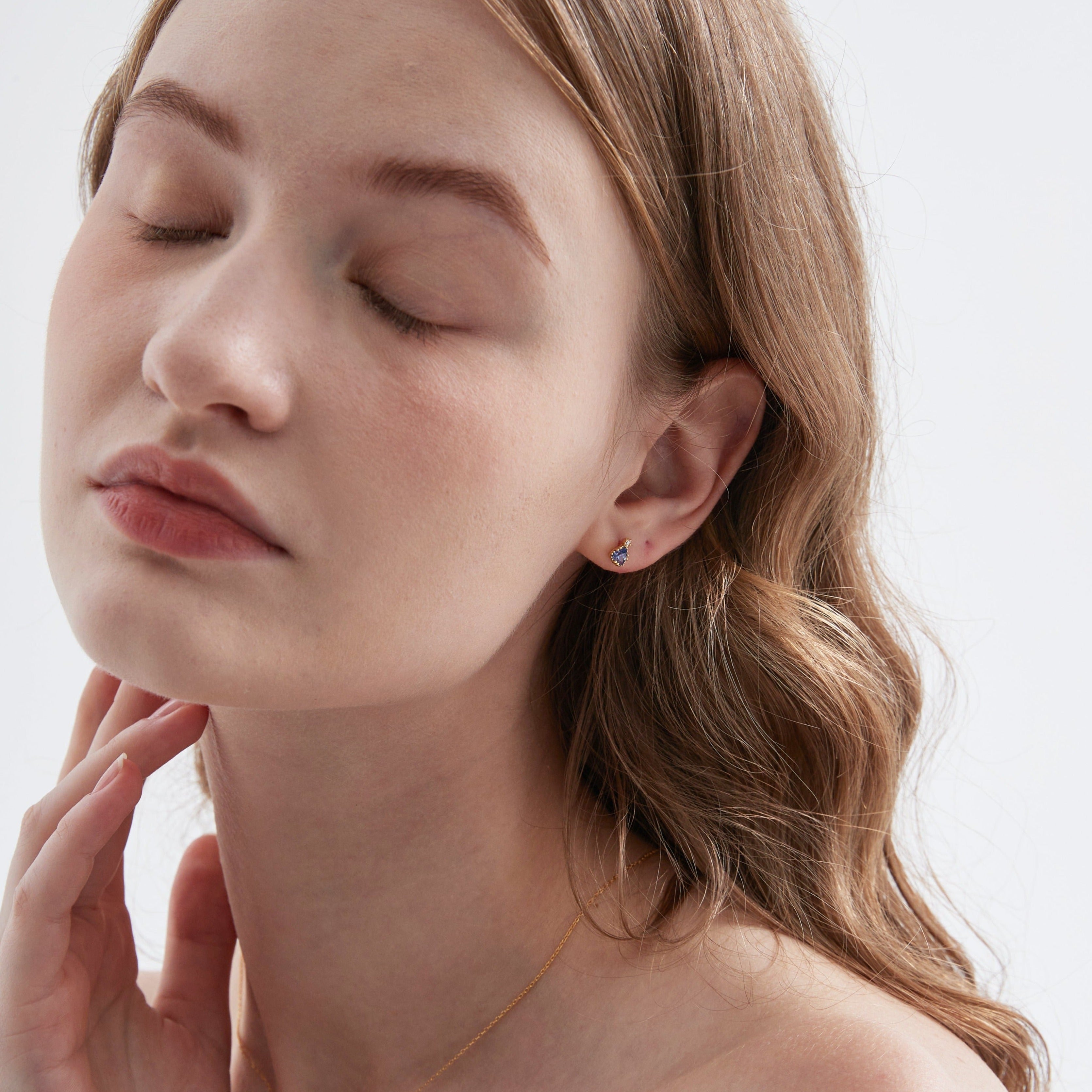 Blue Sapphire Stud Earrings on ear