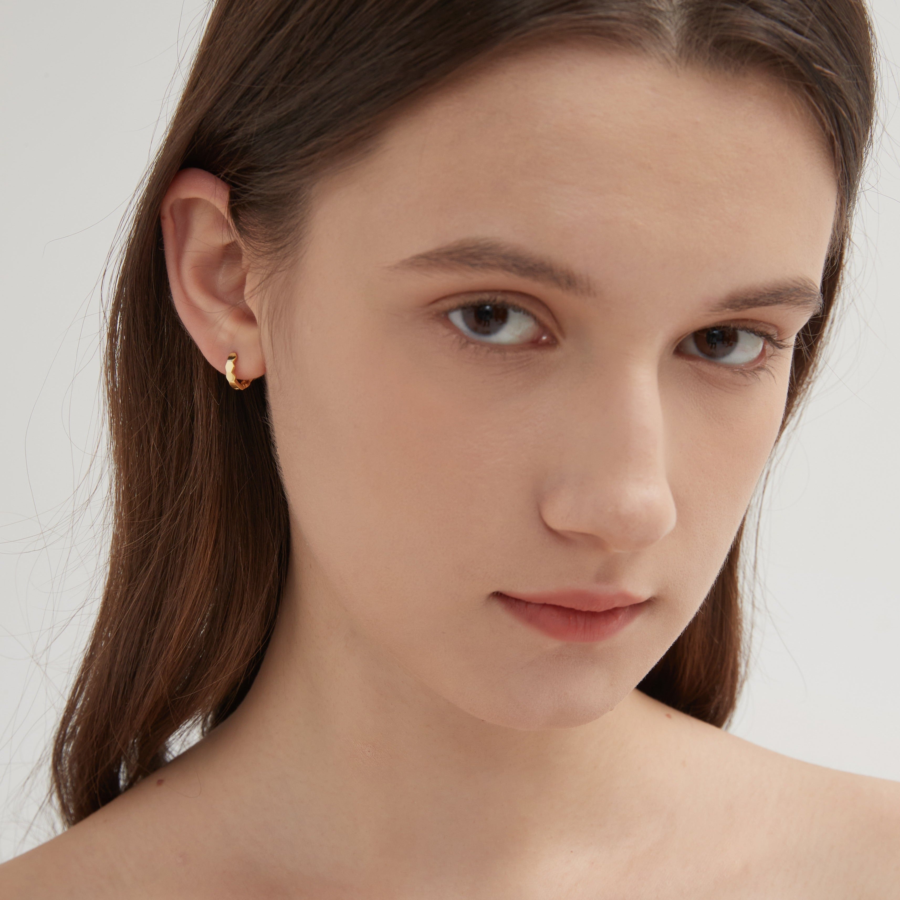 STMG Minimalist Hexagon Hoops in gold on ear