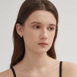 Diamond Stud Earrings in gold on ear