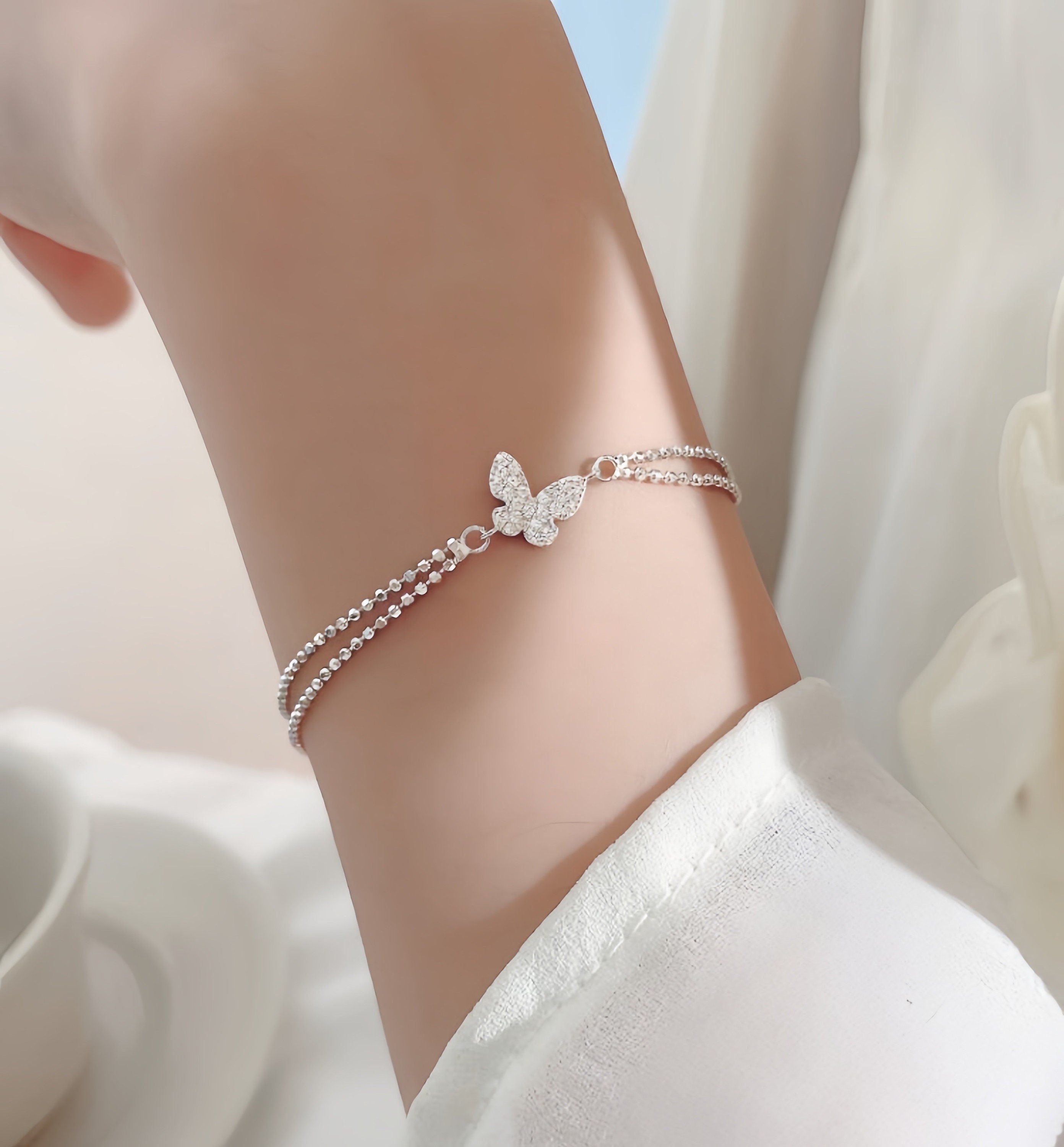 STMG Tiny Butterfly Bracelet on hand